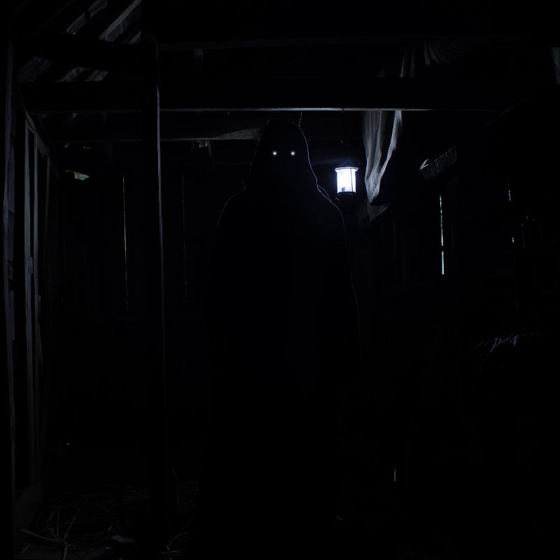 Dark, narrow hallway with a light source at the end