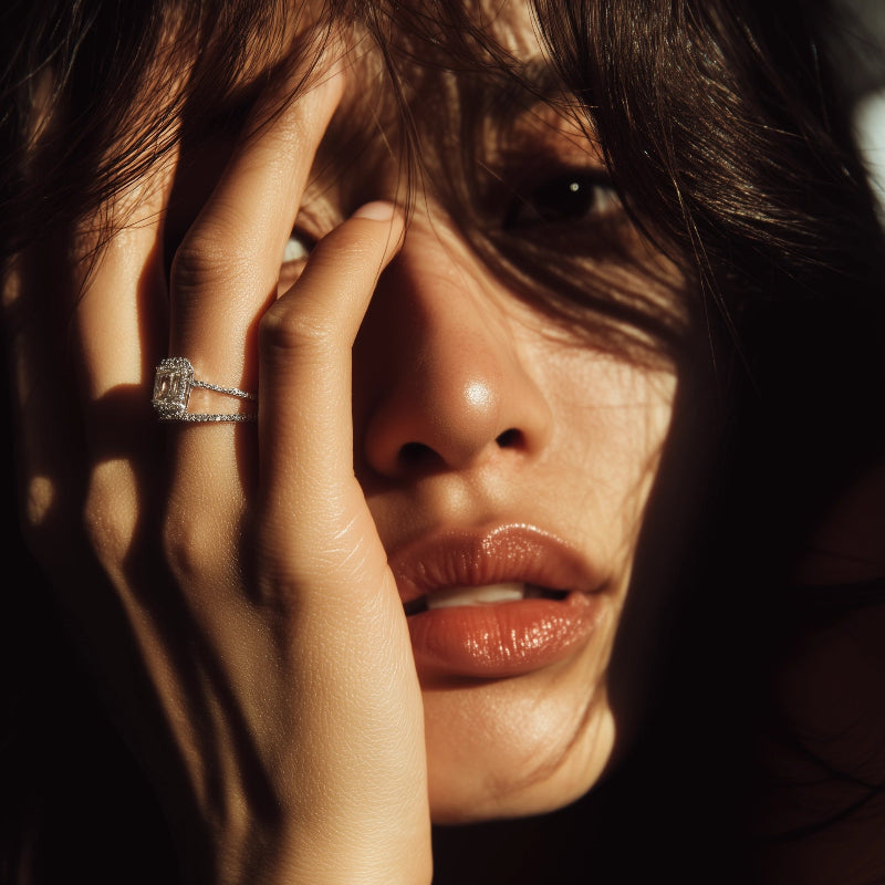Close-up of a person with a ring on their finger, with a dark background
