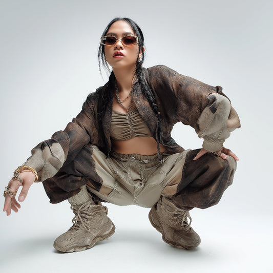 Person wearing a stylish outfit with sunglasses on a white background