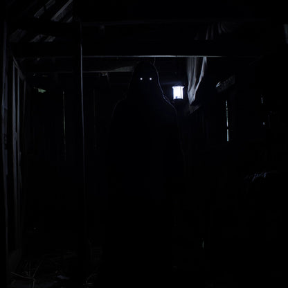 Dark, narrow hallway with a light source at the end
