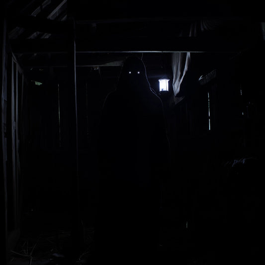 Dark, narrow hallway with a light source at the end