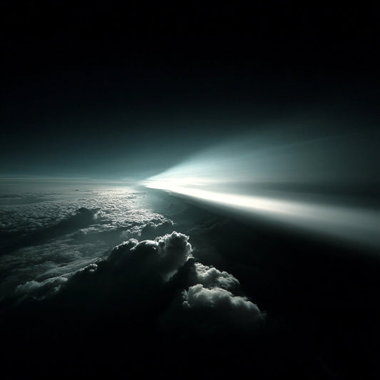 Light beam piercing through clouds from a dark sky