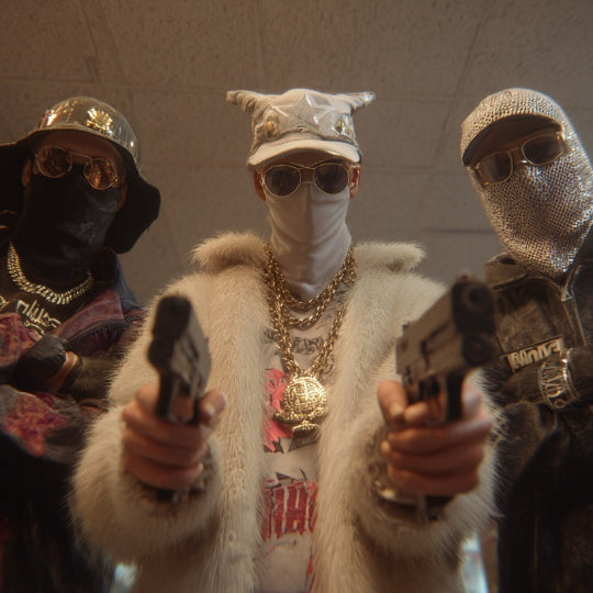 Three individuals in a room, wearing masks and holding guns.