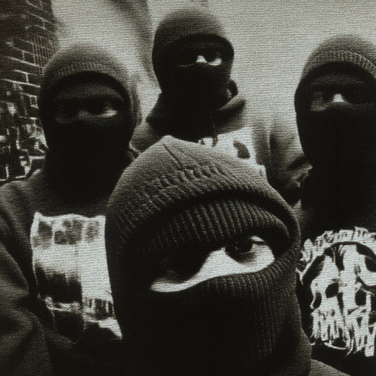 Group of people wearing balaclavas with a brick wall background