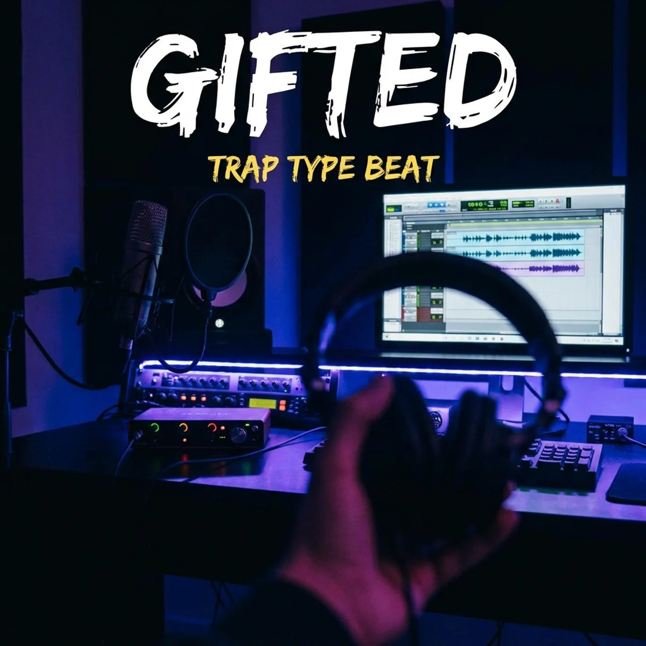 Music production setup with headphones and computer, text 'GIFTED TRAP TYPE BEAT' above.