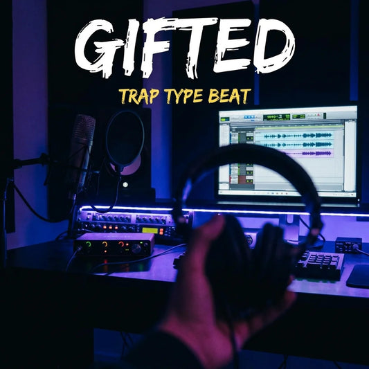 Music production setup with headphones and computer, text 'GIFTED TRAP TYPE BEAT' above.