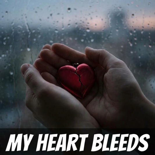 A pair of hands holding a small red heart-shaped locket with a visible crack, set against a rain-splattered window background. The text 'MY HEART BLEEDS' appears in bold white letters at the bottom.